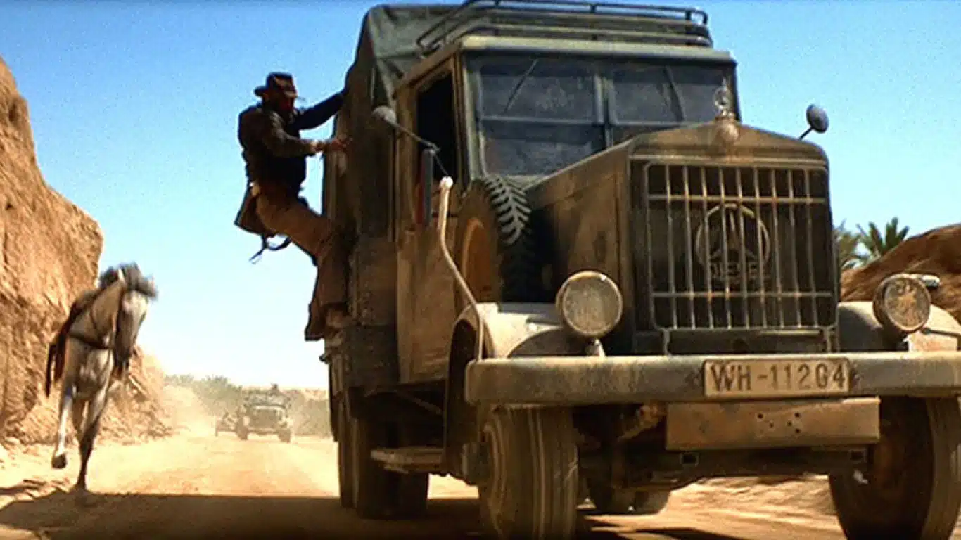 Top 10 Movie Stunts of All Time - Indiana Jones: Raiders of the Lost Ark (1981): Under the moving truck stunt
